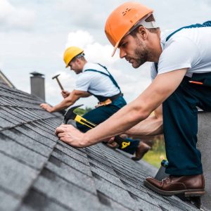 selective-focus-of-handsome-handyman-repairing-roof-with-coworker.jpg